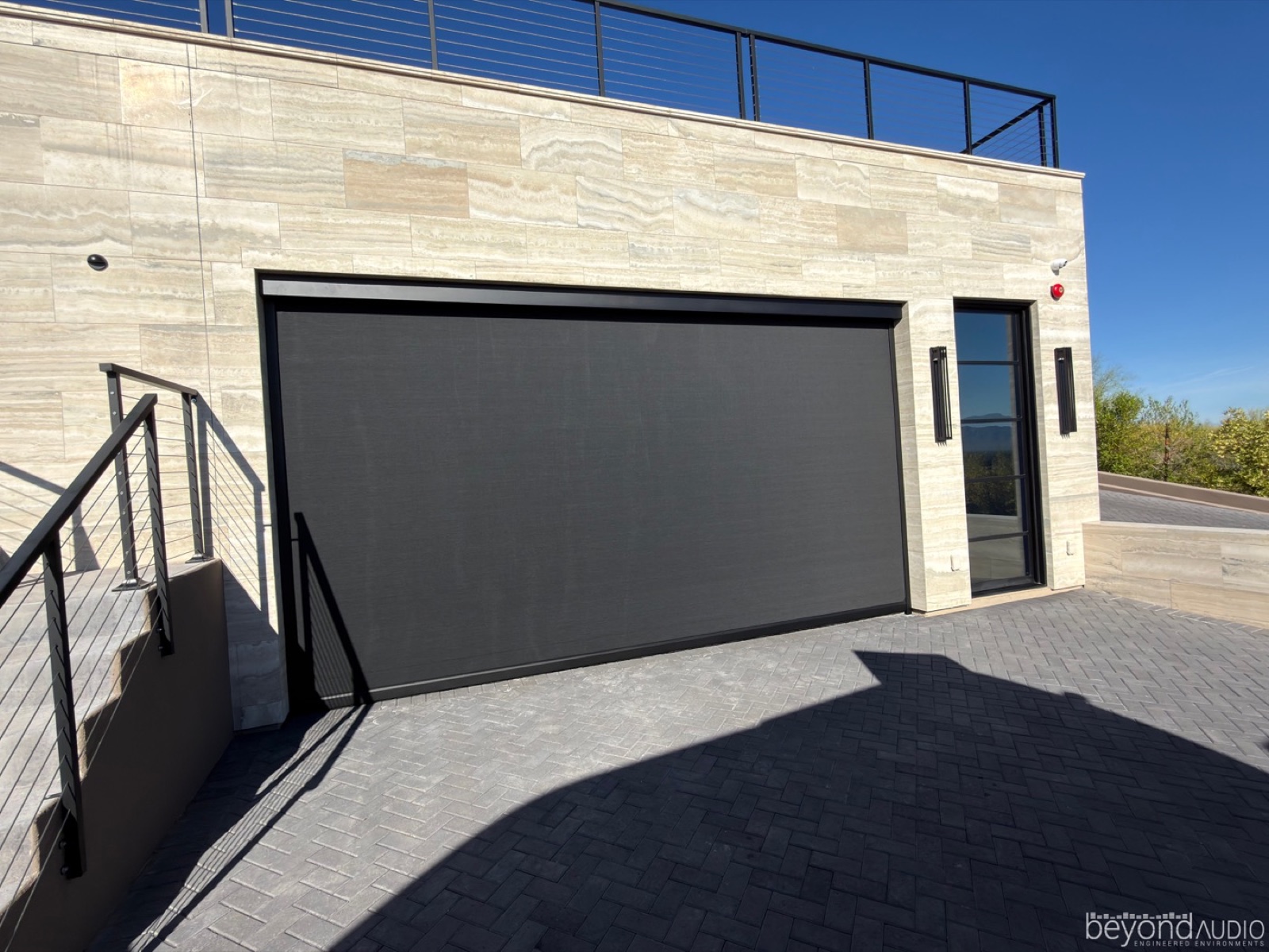Motorized exterior solar screen on a patio
